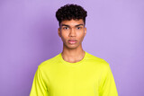 Photo of serious dark skin charming young man wear lime t-shirt isolated on violet purple color background