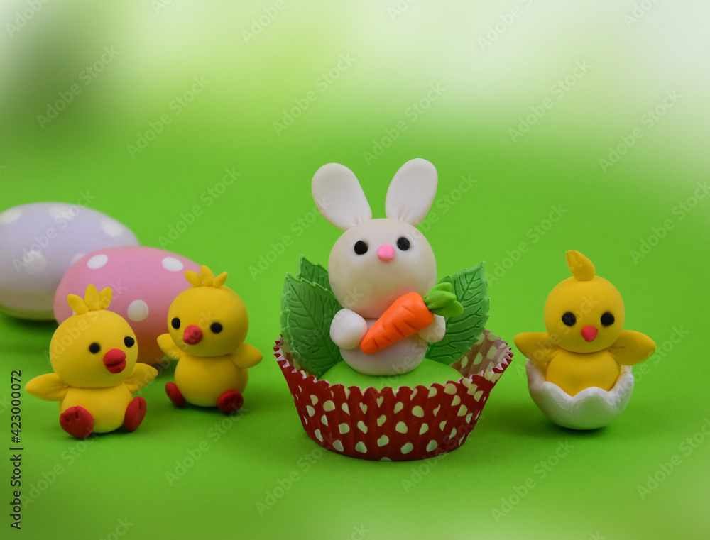 Cute easter baby bunny and chicks toys on a green background stock images. Easter decoration with cute little rabbit, chickens and polka dot eggs images. Easter animal figurine still life stock photo Cute easter baby bunny and chicks toys on a green background stock images. Easter decoration with cute little rabbit, chickens and polka dot eggs images. Easter animal figurine still life stock photo