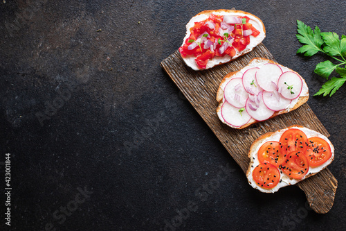 bruschetta vegetable tomato, radish onion cream cheese on the table cooking meal snack top view copy space food background 
