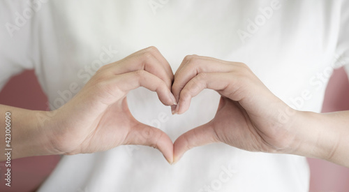 woman making hands in heart shape, heart health insurance, social responsibility, donation charity, world heart day, appreciation concept, world mental health day, love yourself, Self acceptance photo