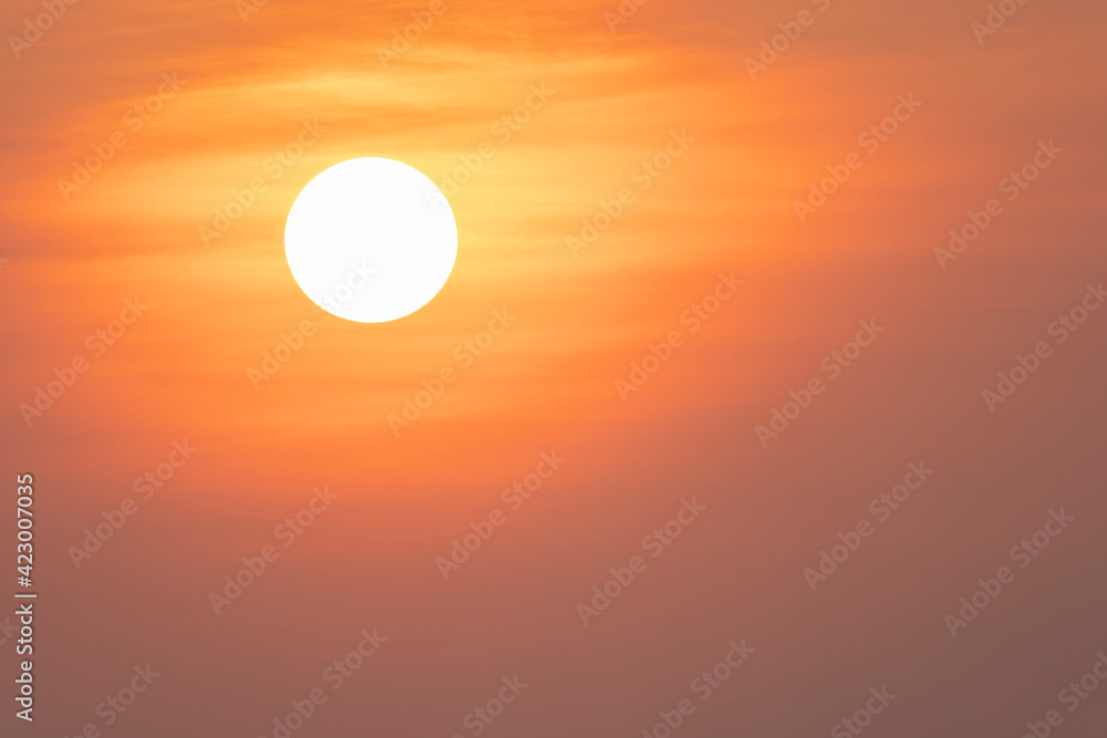 Big sun at sunset in the orange yky