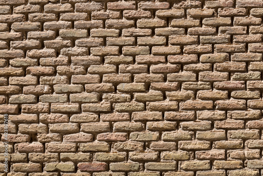 Wall of yellow bricks with cement layers Wall of yellow bricks with cement layers