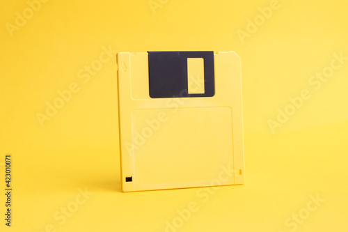 Yellow floppy disk 3.5 Inch on yellow background.