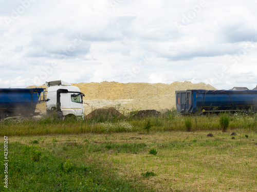 Dump Trucks carry sand for road construction.