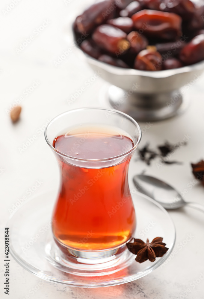 Glass of tasty Turkish tea on light background Glass of tasty Turkish tea on light background