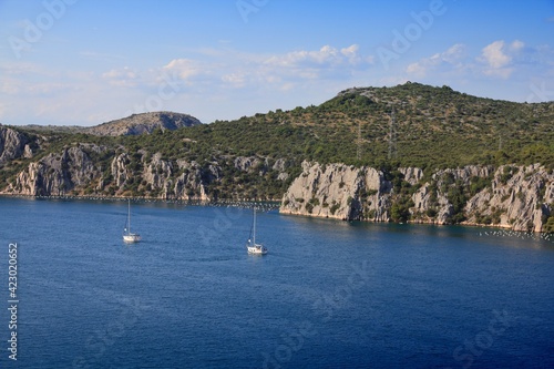 Sailboats and mussel farms at river Krka estuary in Croatia. Croatian landscape.