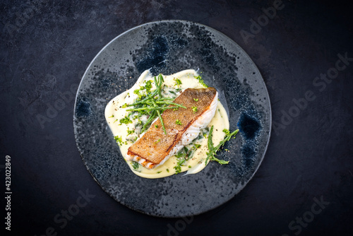 Fotografia Modern style traditional fried skrei cod fish filet with mashed potatoes and gla