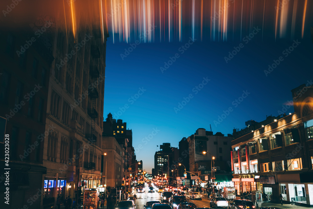 Illuminated city street in evening
