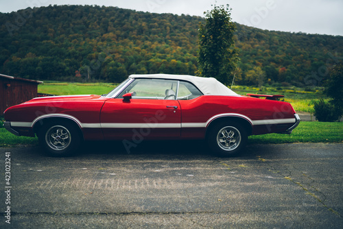 Retro red vintage American car on asphalt road