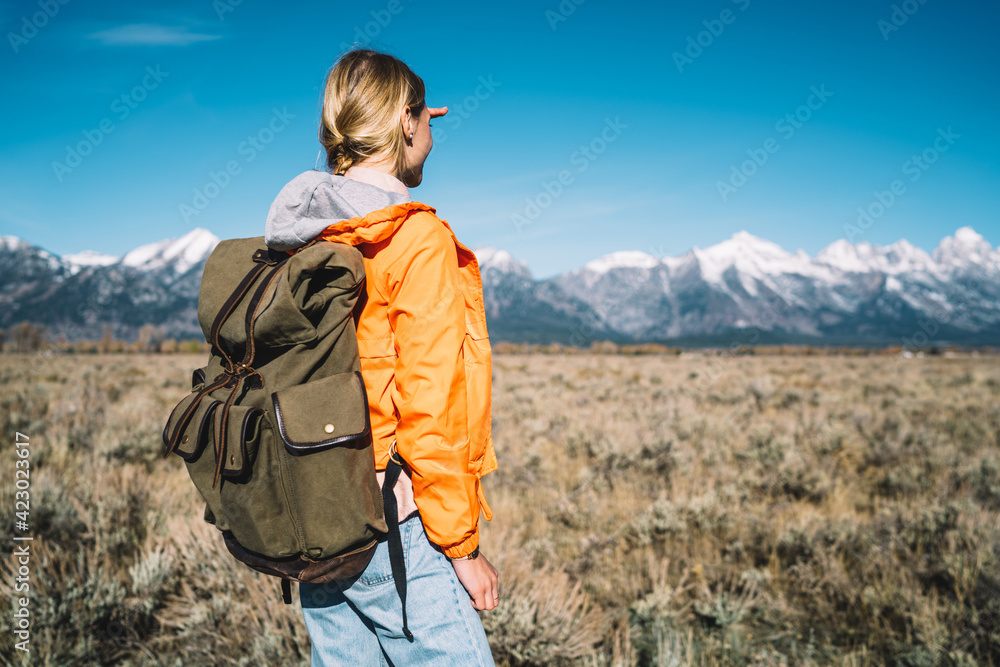 Anonymous woman looking at mountain ridge