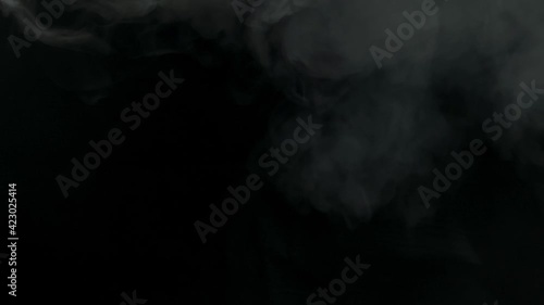 Realistic smoke clouds on a black background.