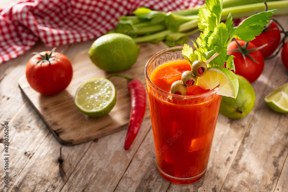 Bloody Mary cocktail in glass on rustic wooden table