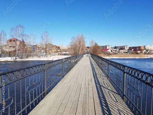 Pedestrian bridge over a winter lake