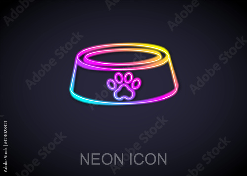 Glowing neon line Pet food bowl for cat or dog icon isolated on black background. Dog or cat paw print. Vector