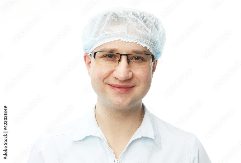 Portrait of a male doctor with glasses and hat smiling and looking to camera Portrait of a male doctor with glasses and hat smiling and looking to camera