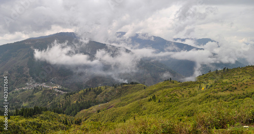 Himalian valley with clouds across the ridges