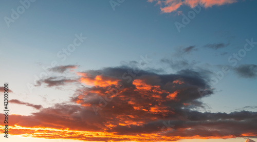 Sunset sky with dramatic orange clouds. Nature sky clouds background.  © Inga Av