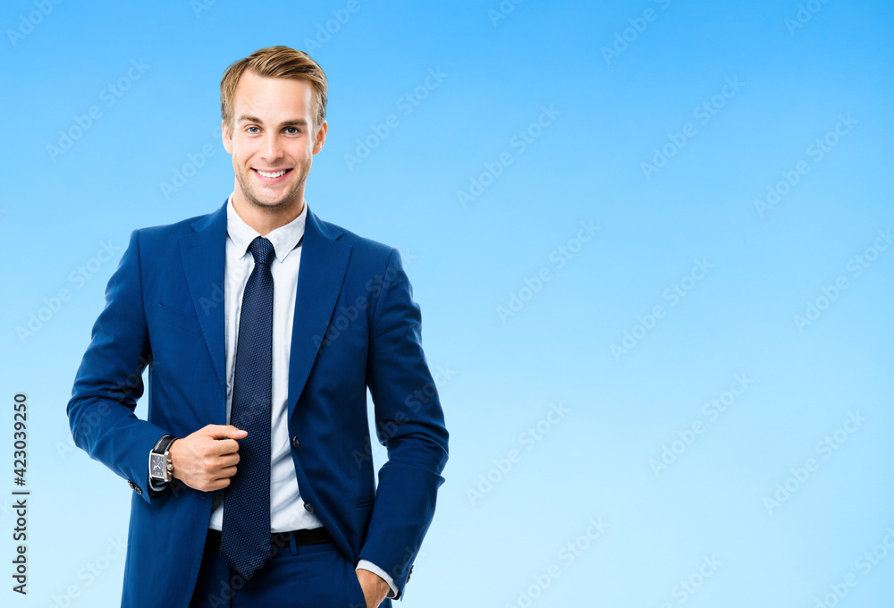 Portrait of happy smiling young confident businessman, isolated over blue color background. Business success concept. Portrait of happy smiling young confident businessman, isolated over blue color background. Business success concept.