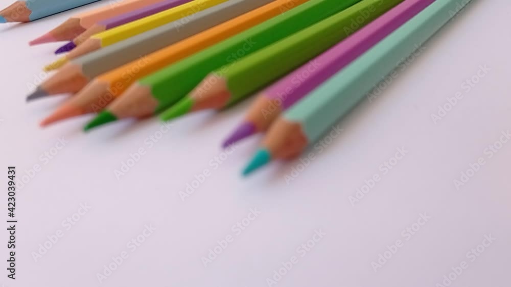 rolling the pencil colors on the white paper rolling the pencil colors on the white paper