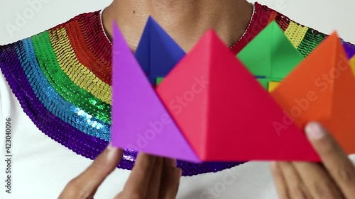 Modeling outfit  for the Gay Pride Day.  Sequined T-shirt and paper crown. Fixed camera, hispanic modelm rainbow. photo