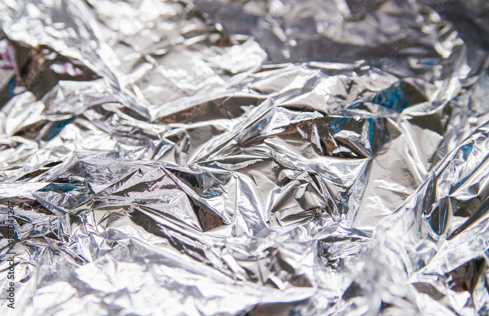 Crumpled silver foil.Bright festive background and texture.