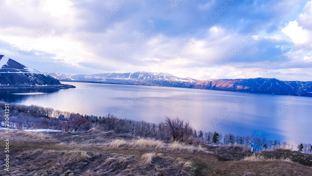 Mountain Lake Sevan at sunset. Travel to Armenia in spring