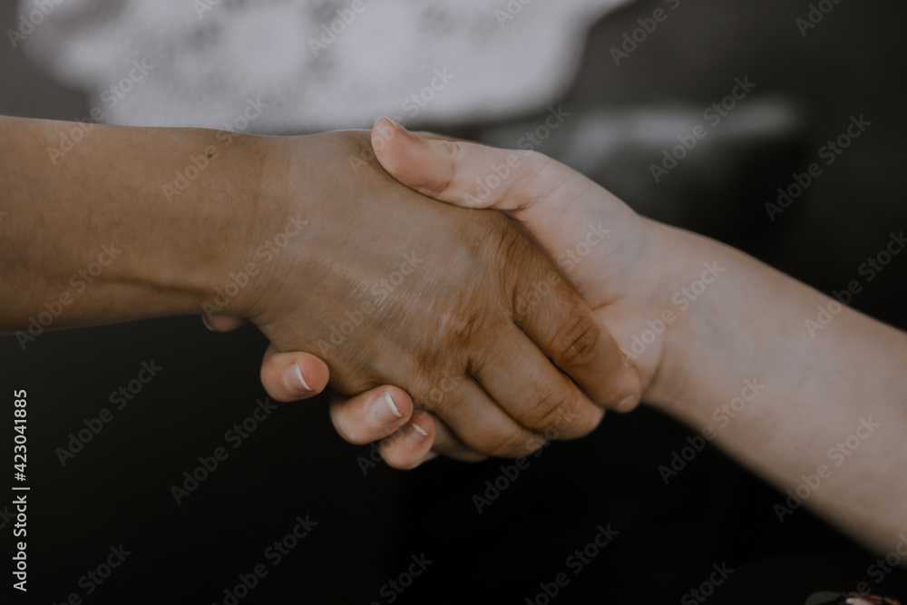 close up of two hands shaking hands