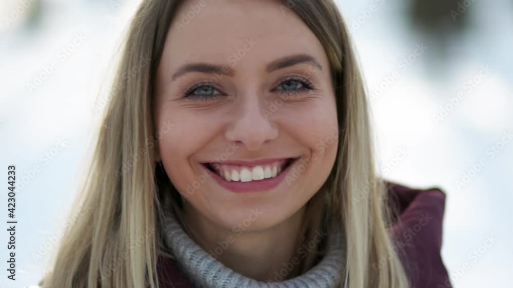 Closeup face of beautiful blond sexy smiling woman with long hair. Portrait of gorgeous girl looking to camera Closeup face of beautiful blond sexy smiling woman with long hair. Portrait of gorgeous girl looking to camera