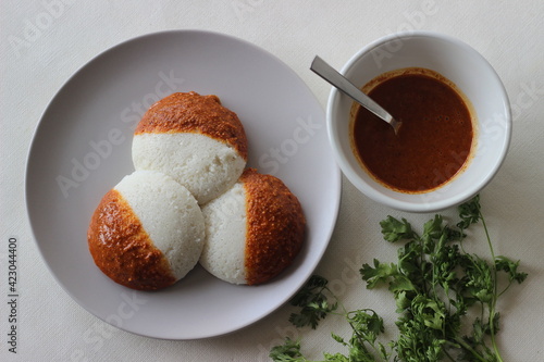 Idli half covered with podi chutney also named as gunpowder. Podi is made of ground pulses, dried red chillies and pepper. photo