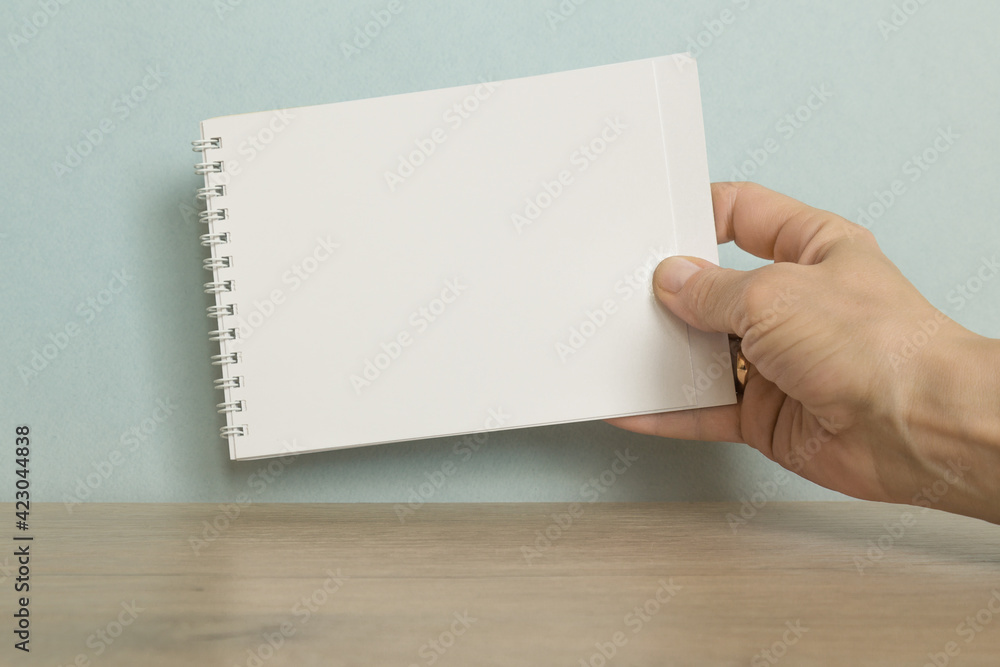THE BLANK in the hand on a blue background THE BLANK in the hand on a blue background