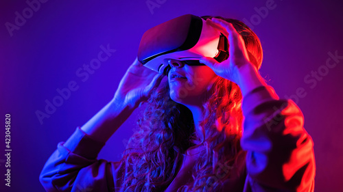 Young girl in virtual reality glasses at home