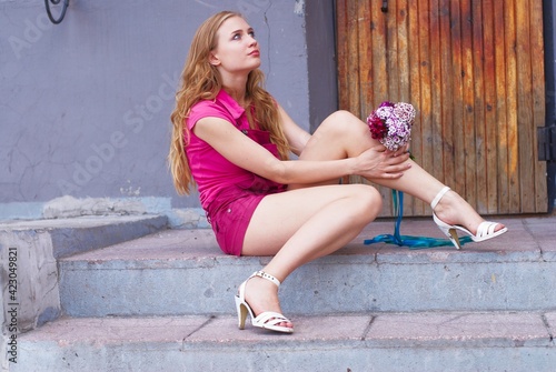 Waiting pretty girl with bouquet photo