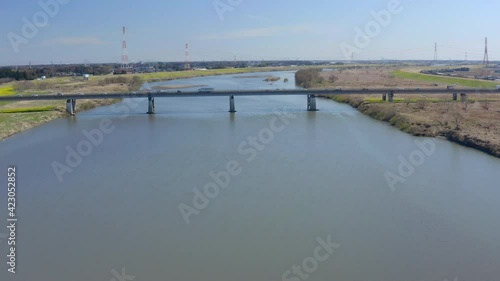 Wallpaper Mural Aerial rotating drone shot of a bridge with cars and trucks crossing over. Bridge crossing the Tonegawa river in Sashima district Ibaraki Japan Torontodigital.ca