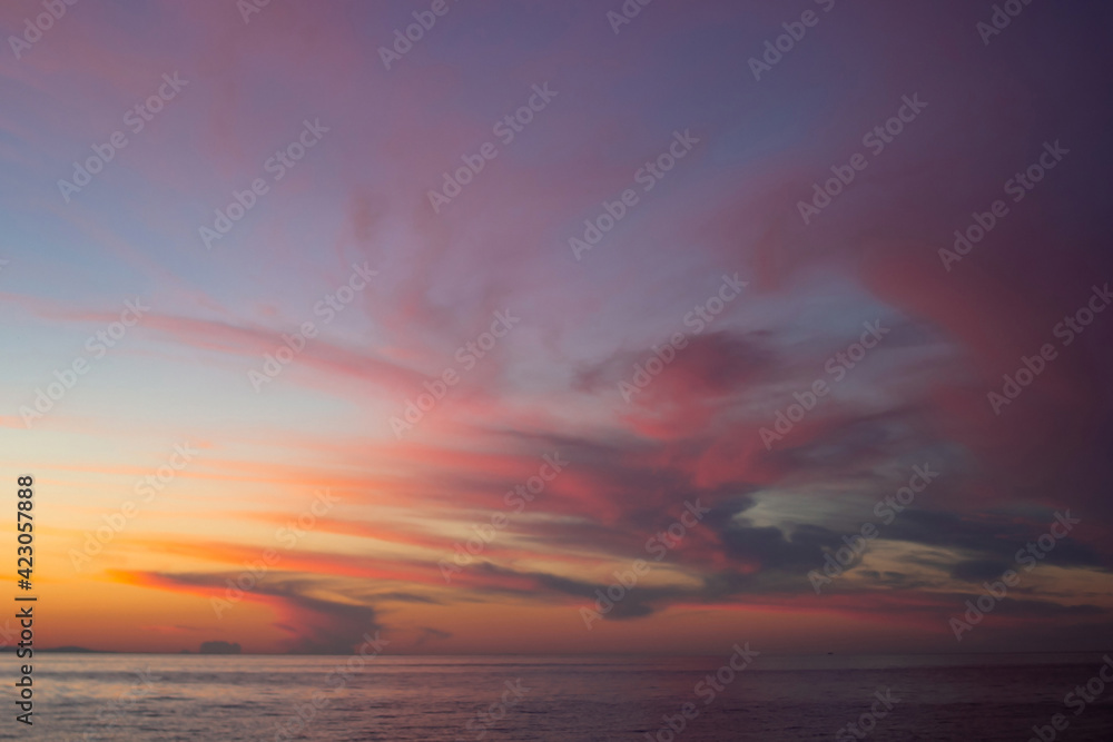Dramatic purple pink yellow red clouds after sunset in dusk on Lake Baikal, scenic seascape, dark moody style