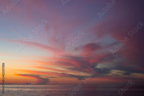Dramatic purple pink yellow red clouds after sunset in dusk on Lake Baikal, scenic seascape, dark moody style © Clara_Sh.