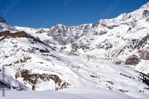 Snow capped mountains, snowfields and glaciers at Zermatt, Switzerland, seen from Gornergrat railway station. Photo taken March 23rd, 2021.