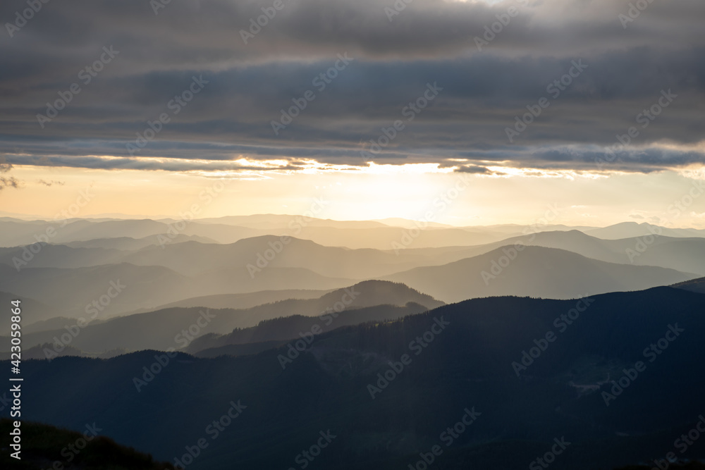 view of sunset above mountains peak