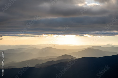 view of sunset above mountains peak © phpetrunina14