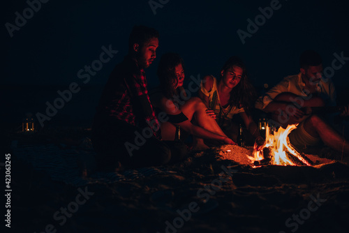 Group of happy friends with guitar having fun outdoor