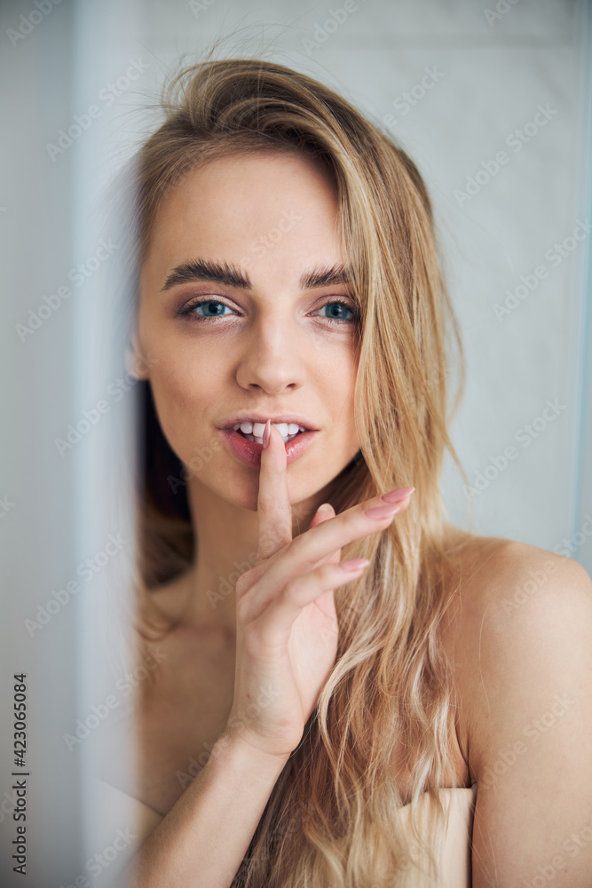 Cute young female making a silence sign Cute young female making a silence sign