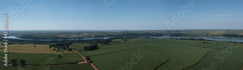 panoramic view of the Tiete River waterway with several plantations nearby photo