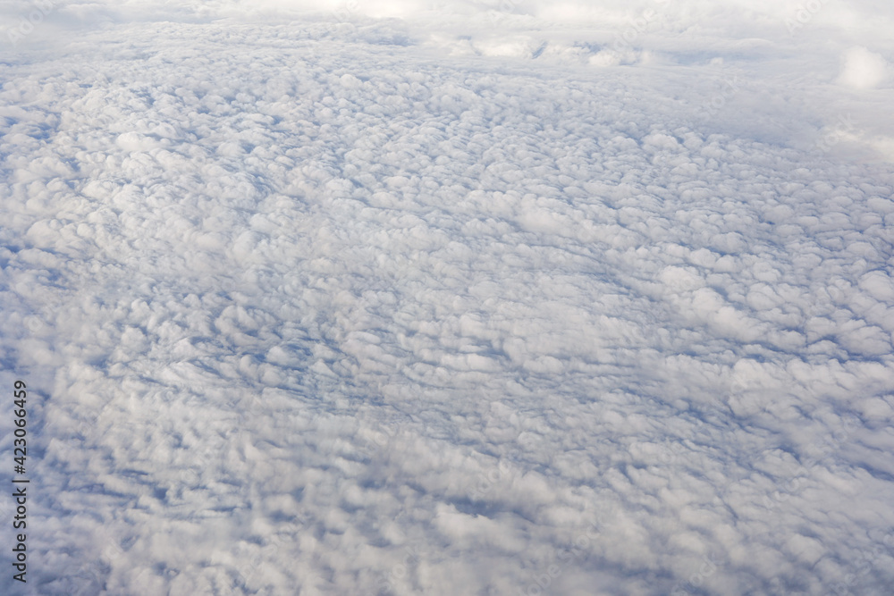 Fluffy clouds that looks as flat surface as seen from commercial airplane Fluffy clouds that looks as flat surface as seen from commercial airplane