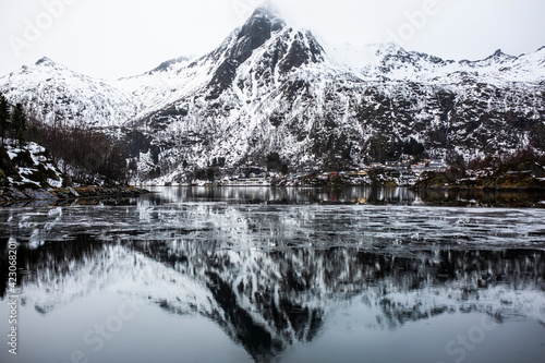 Magnificent scenery of sea and mountains under gray cloudy sky in winter in Norway photo