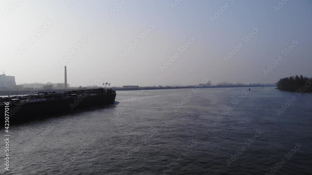 Aerial view, flying over a cargo ship in the river. Import export concept Aerial view, flying over a cargo ship in the river. Import export concept