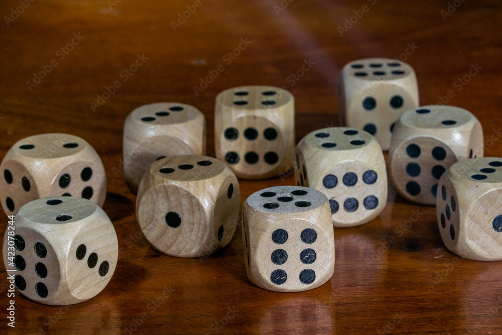 Wooden dice for board game on wooden table. Wooden dice for board game on wooden table.