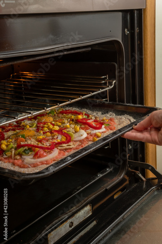 Putting an artisan pizza in the oven