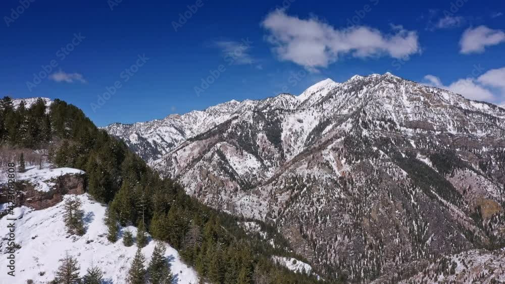 Flying over mountain ridge looking over canyon moving past pine trees in Utah. Flying over mountain ridge looking over canyon moving past pine trees in Utah.