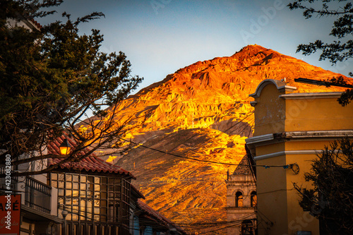 colonnial house in potosi, with cerro rico mountain in background, bolivia photo