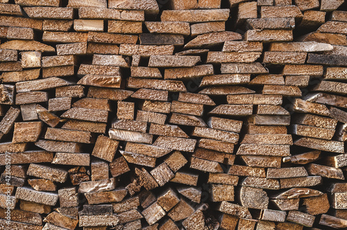 Stacked timber chopped wood board close-up, firewood background pattern 