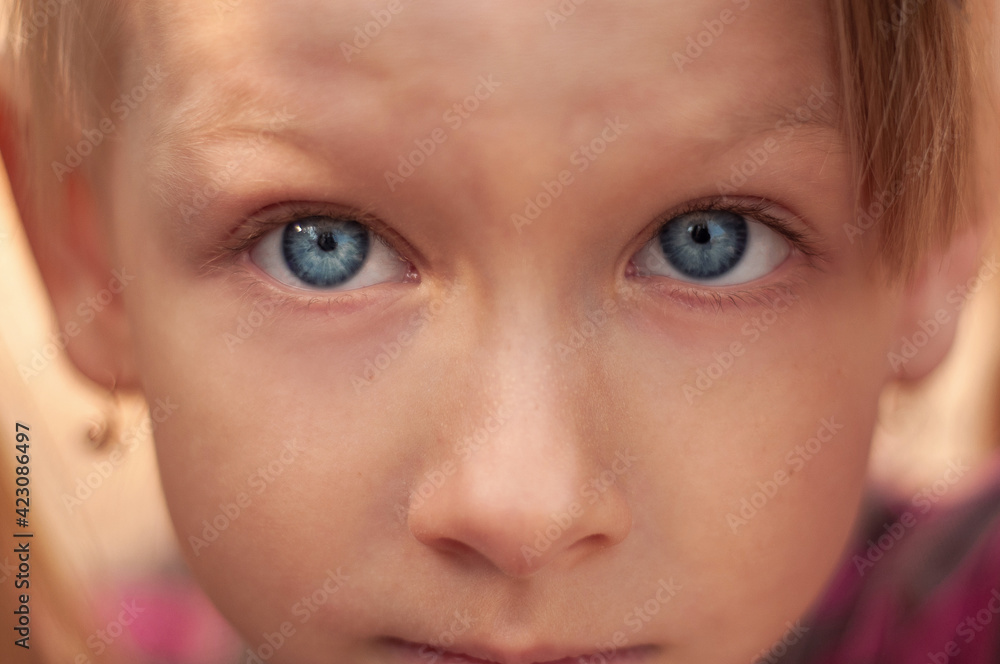 Close-up portrait of a blue-eyed blonde girl. Close-up portrait of a blue-eyed blonde girl.